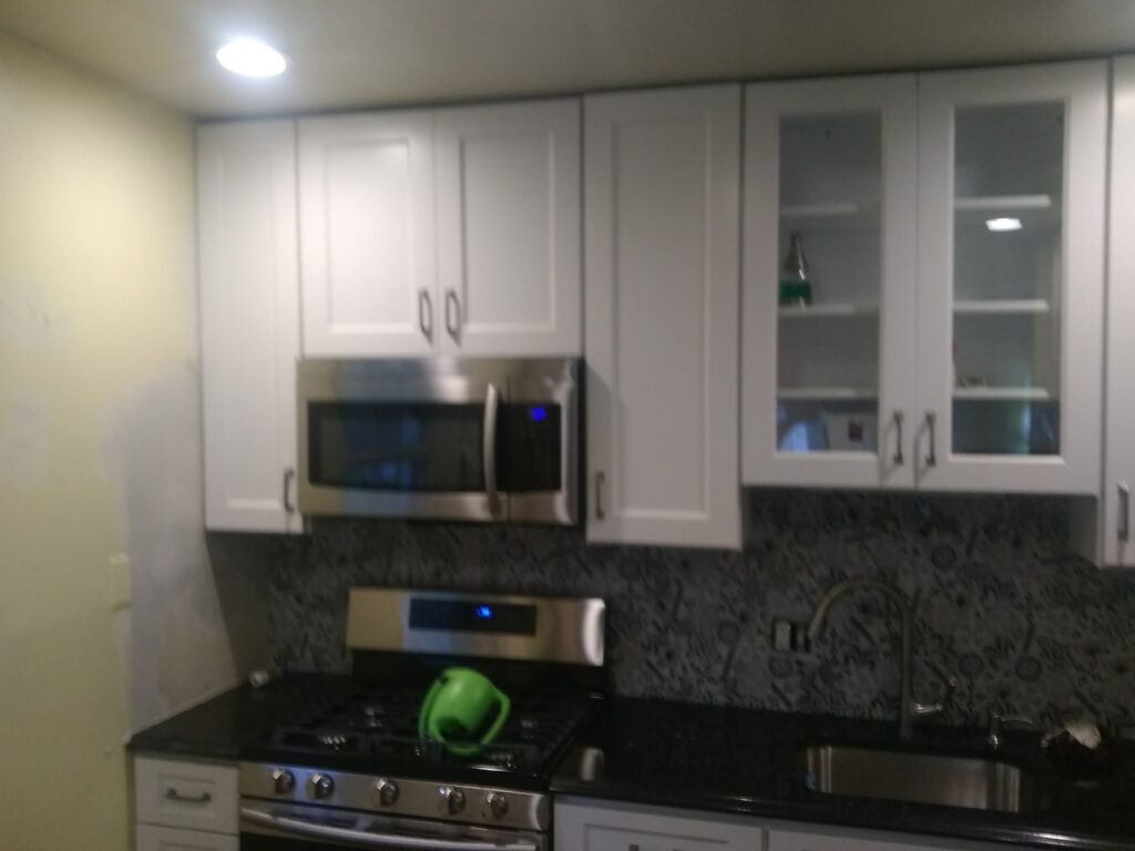 Finished kitchen remodel with white cabinets and granite counters in a Maryland home