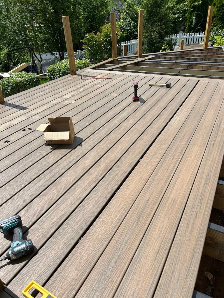 Composite decking boards being installed on pressure treated framing in Frederick County